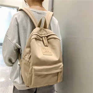 Minimalist beige nylon backpack for women with light brown patch in Korean style