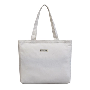 Minimalist white canvas tote bag with Believe in yourself label and large capacity design