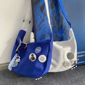 Detailed view of blue and white nylon dumplings bags with astronaut charms and badges