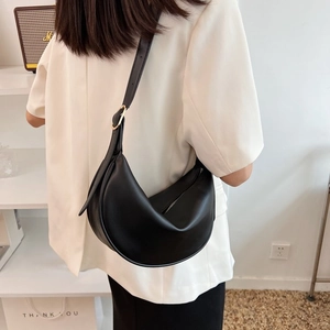 Minimalist black crescent shoulder bag in PU leather with adjustable golden buckle strap
