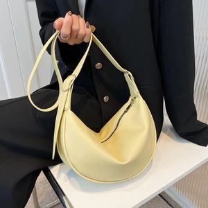 Minimalist yellow hobo shoulder bag in smooth faux leather with adjustable strap