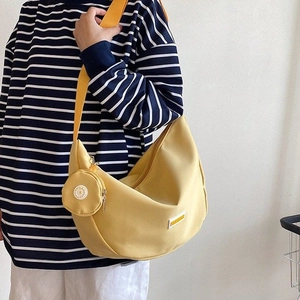 Bright yellow nylon crescent crossbody bag with detachable round coin purse on wide strap