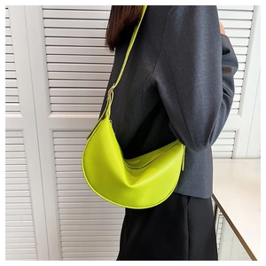 Close-up of vibrant neon green hobo shoulder bag with sleek leather finish