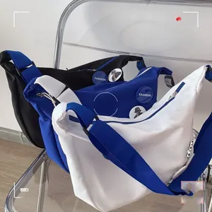 Nylon crescent messenger bags in black, blue, and white with adjustable wide straps