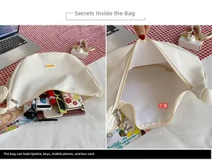 Detail showing internal capacity of the canvas crossbody bag with daily essentials