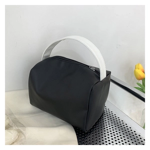 Macro detail of minimalist black waterproof makeup bag with contrasting white handles