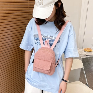 Pink corduroy mini backpack for women featuring vertical stripes and front pocket