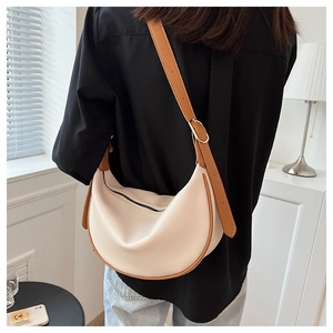 Detailed back view of a minimalist hobo crossbody bag with brown leather trim and gold buckle
