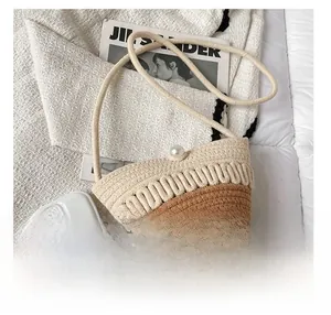 Detail view of woven bucket bag with pearl accent and stylish two-tone straw design