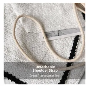 Detailed close-up of a white tweed bucket bag featuring a removable rope shoulder strap
