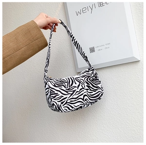 Detail of a half-moon shoulder bag with bold black and white zebra print for women