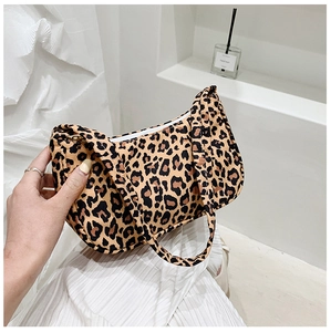 Detail of leopard print canvas crescent bag with matching strap and zip closure