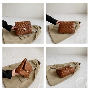 Detail view of brown quilted shoulder bag with gold chain strap and metal clasp closure