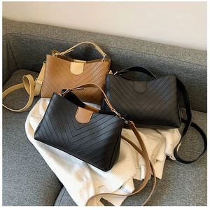 Three V-quilted small square shoulder bags in brown, black, and bicolor leather textures