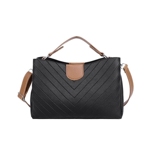 Minimalist black and brown crossbody bag with V-shaped quilting and trapezoid structure