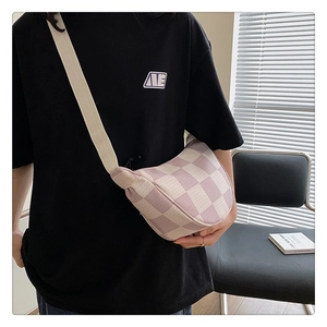 Detailed texture of purple and beige checkered canvas crossbody bag with strap