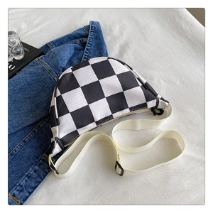 Close-up of black and white checkered canvas waist bag with adjustable strap and zipper