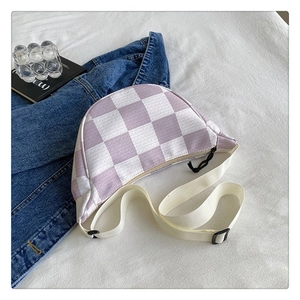 Detailed shot of purple and white checkered half-moon crossbody bag with adjustable strap