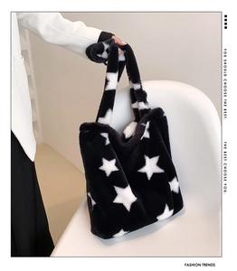 Detail of plush tote bag with black and white star pattern and soft faux fur texture
