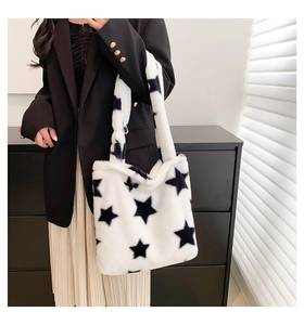 Furry tote bag with star pattern worn on shoulder by model in minimal chic urban setting