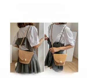 Detail of hand-woven beige bucket bag showing pearl closure in shoulder and crossbody modes