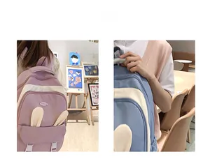 Close-up of cute school backpacks with bunny ears in pink and blue colors