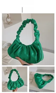 Detail shot of green ruched cloud bag showing premium PU leather texture and finish