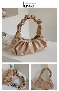 Detail of khaki PU leather cloud bag featuring pleated handle and soft scrunched texture