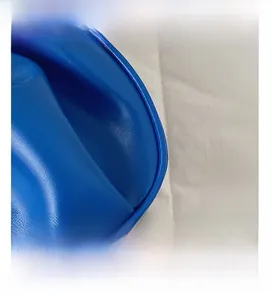 Macro detail of royal blue pebbled leather surface with fine stitching on shoulder bag