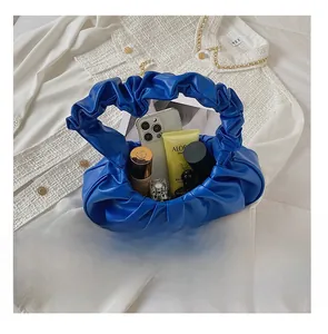 Detail showing the inner storage capacity of the pleated royal blue cloud bag