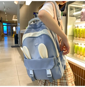 Side view of cute blue and cream school backpack with bunny ears and Fashion logo