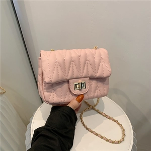 Chic pink quilted crossbody bag with golden chain strap and metallic twist lock clasp