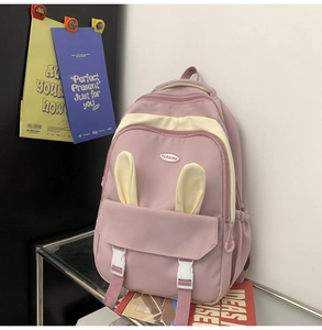 Detailed view of a purple school backpack featuring cute rabbit ears and stylish buckles