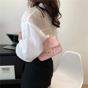 Pink quilted crossbody bag with golden chain strap and wave texture for women