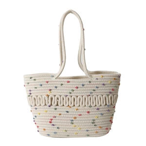 Handmade cream woven straw beach tote bag with colorful pom poms and wave texture