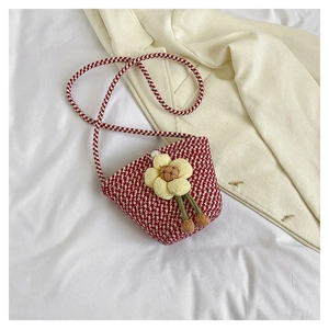 Red and white checkered knitted crossbody bag with a yellow flower and pearl clasp