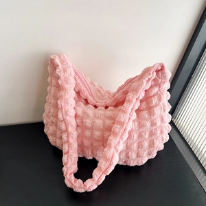 Detail showing pink bubble textured fabric and sturdy zipper on this casual shoulder bag