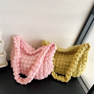 Close-up of pink and mustard yellow popcorn texture fabric on casual tote bags