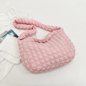 Detail of pink popcorn fabric shoulder bag with unique bubble texture and zipper