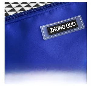 Detail of the royal blue nylon fabric texture and soft rubber label on this hobo bag