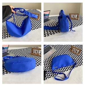 Multi-angle view of Klein blue nylon hobo bag with thick knot shoulder strap detail