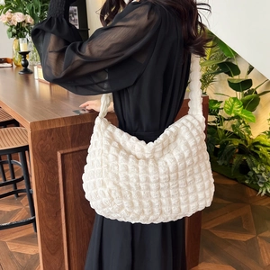 Detail of white puffer shoulder bag with 3D bubble texture and soft ruched design