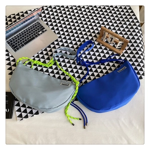 Detail of grey and royal blue nylon crescent bags with bicolor woven rope shoulder straps
