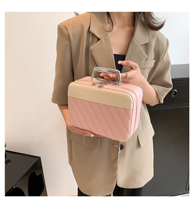 Detail of pink and beige quilted handbag with silver metal handle and luxury texture