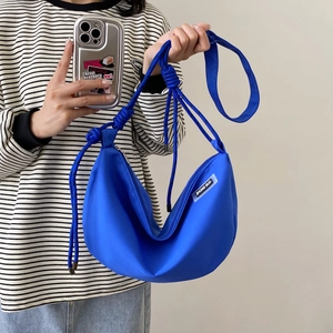 Electric blue nylon hobo bag with thick braided rope strap and zipper closure