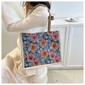 Detail of floral jacquard tote bag with woven handles shown in a modern interior setting