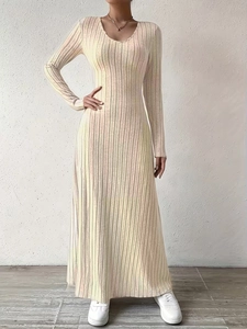 Close-up of long-sleeve V-neck slim knit maxi dress in vertical ribbed cream fabric