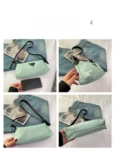 Detailed views of light green nylon underarm bag with black triangle logo and leather strap