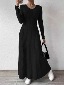 Close-up of the black ribbed knit fabric and slim-fit texture of the long maxi dress