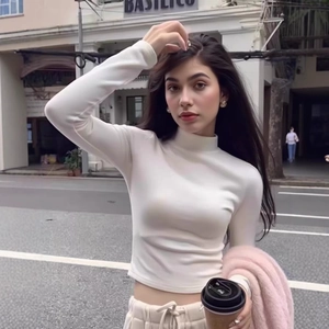 Close-up of the slim-fit white turtleneck top with long sleeves in soft velvet fabric
